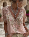 Kirelina - Feminin bluse med broderede blomster og elegant V-hals